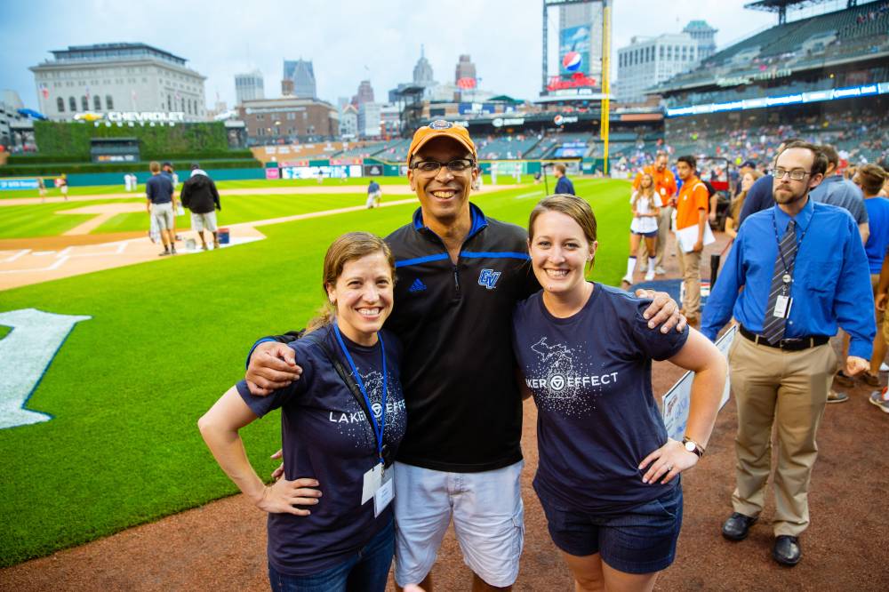three staff members from gvsu Alumni relations pose together on the infield